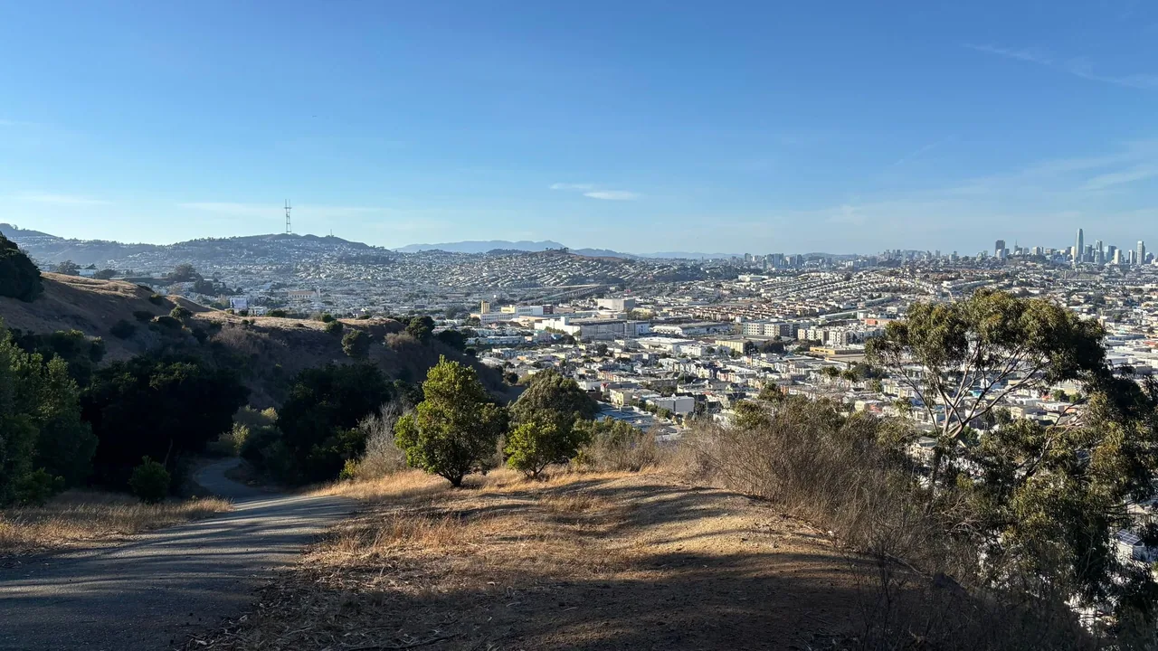 A hillside path at Bay View Park overlooks southeastern San Francisco and distant Twin Peaks.