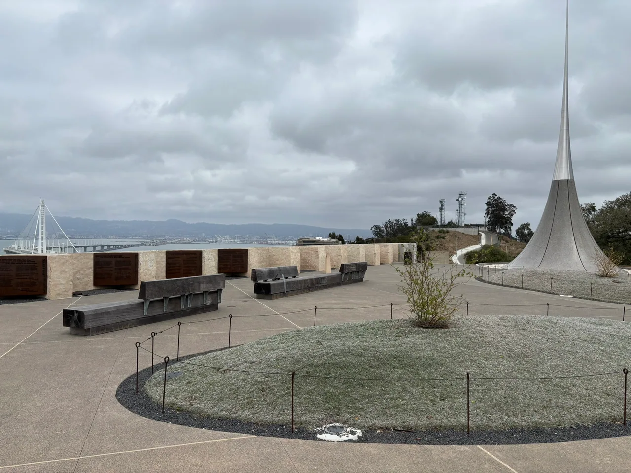 Curved paving, benches, and a tall white sculptural element form a gathering area at Panorama Park.